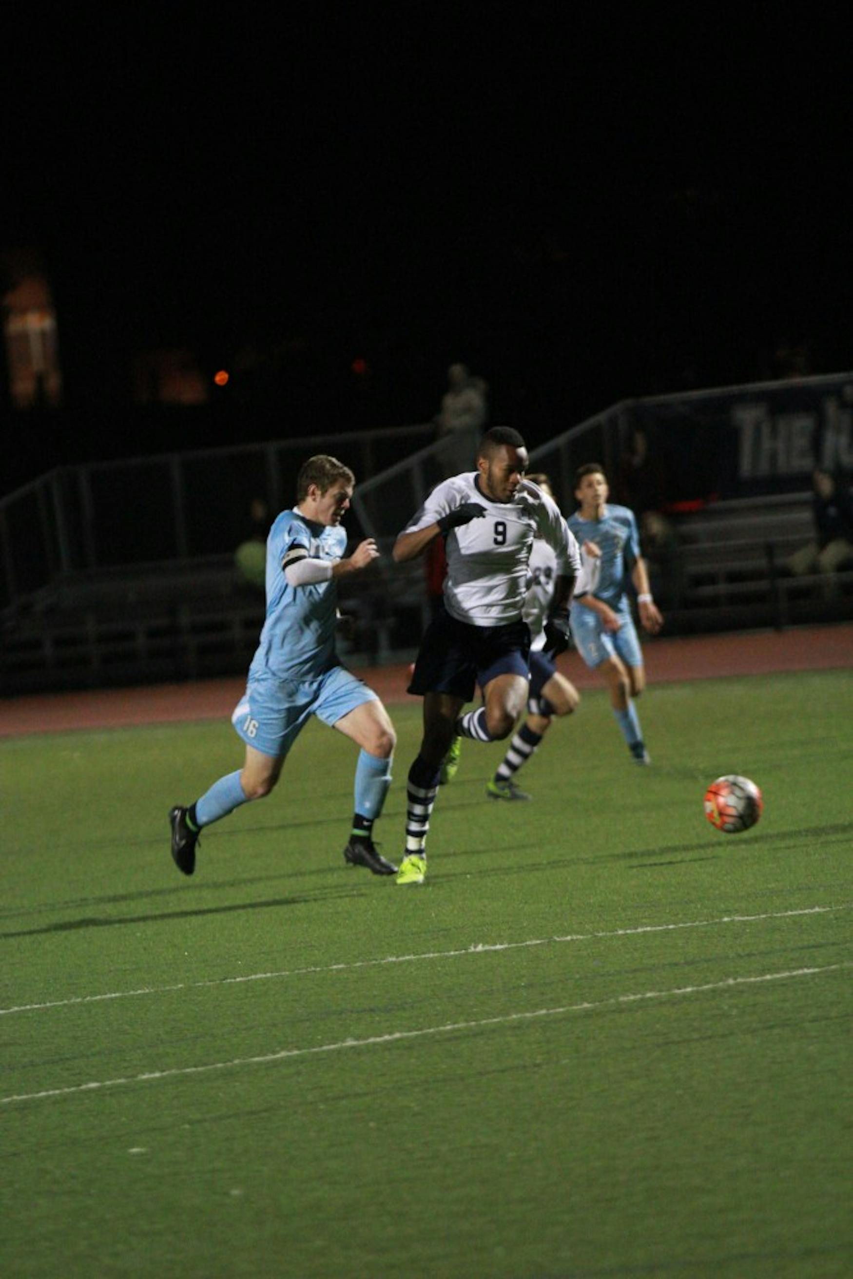 COMING UP CLUTCH: Forward Chris Bradley ’16 dribbles the ball upfield against Lasell College this past Wednesday night.