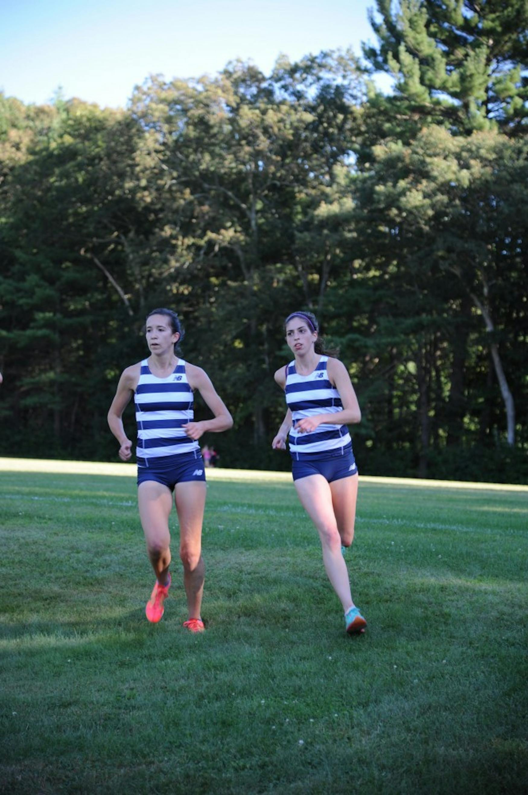 FULL STEAM AHEAD: Kelsey Whitaker ’16 (left), shown at a meet earlier this year, took second in the 1,500-meter run last Friday.
