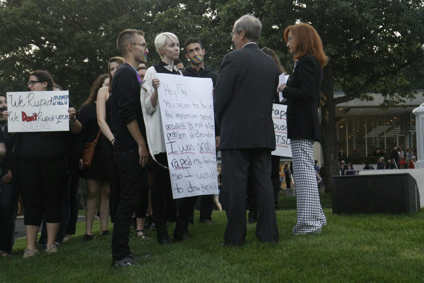 Protesters spoke with University President Frederick Lawrence by the “Light of Reason” installation on Wednesday.