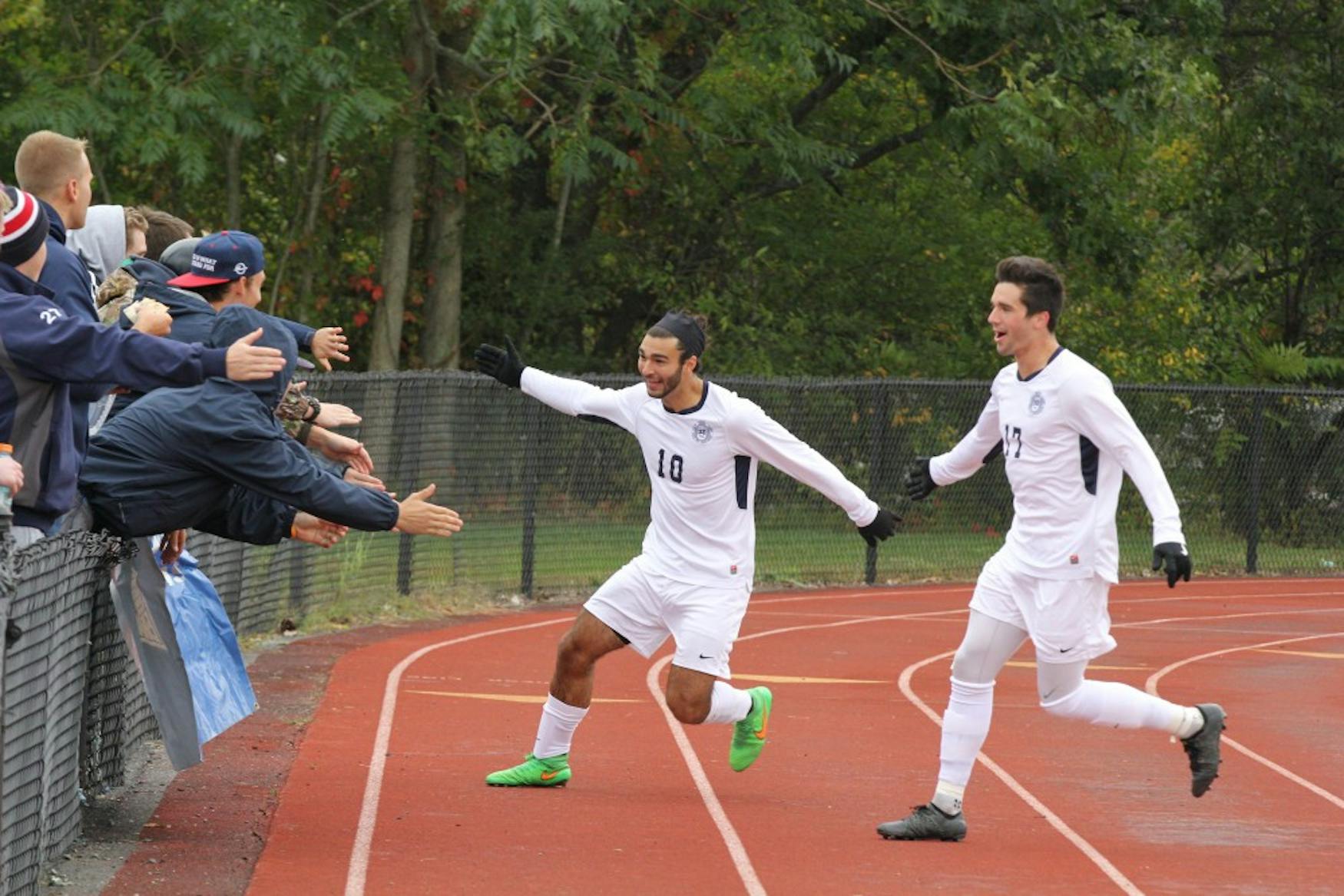OFFENSIVE SURGE: Forward Zach Viera ’17 (right) celebrates a goal at home against Carnegie Mellon University on Oct. 3.