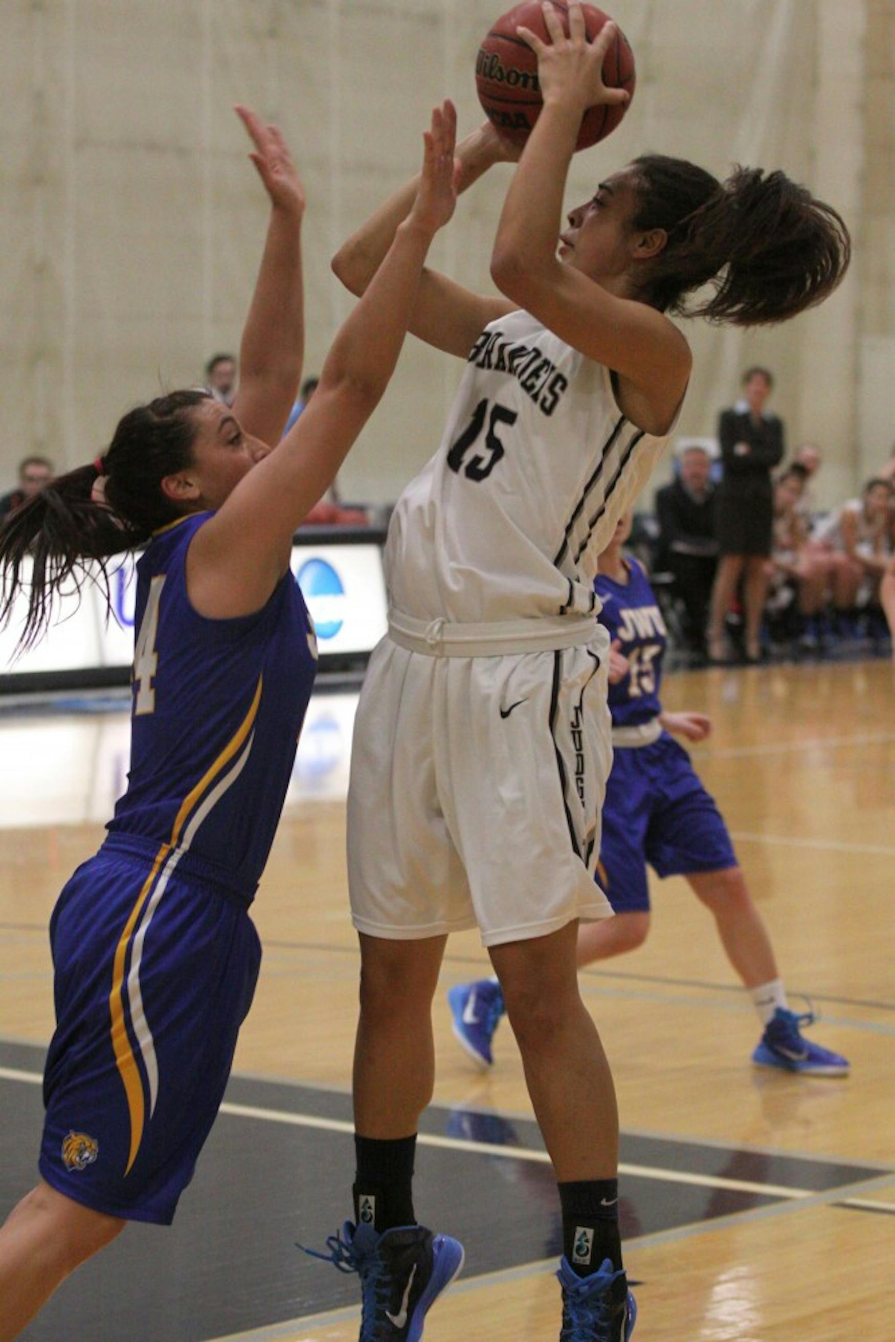 STEPBACK JUMPER: Guard Sydney Sodine ’17 shoots over a defender from Johnson &amp; Wales University in Saturday’s victory.