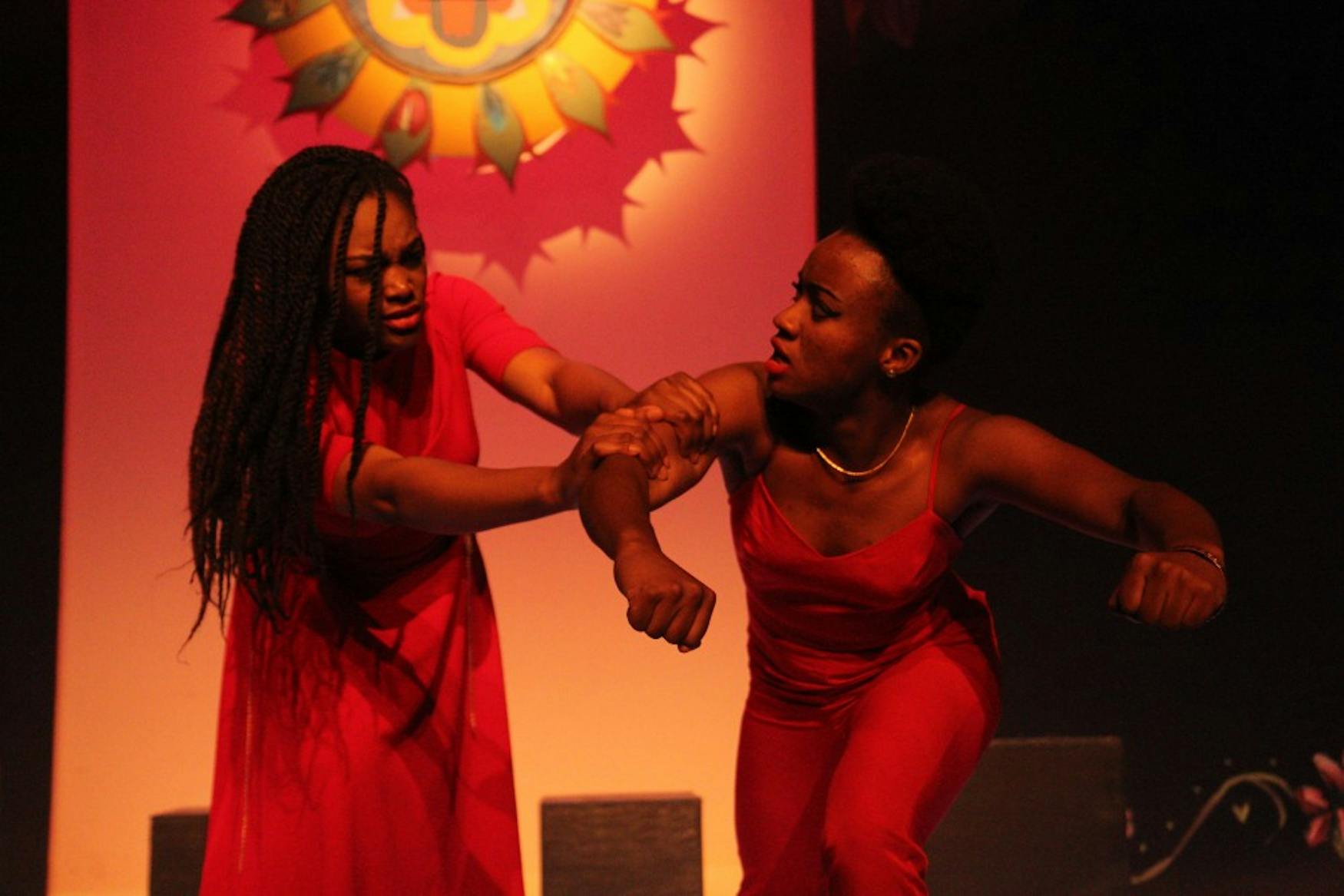 HOME HARDSHIPS: The Ladies in red, Nyah Macklin ’15 (on the right) and Oye Ehikhamhen ’17 (on the left) engage in a domestic struggle.