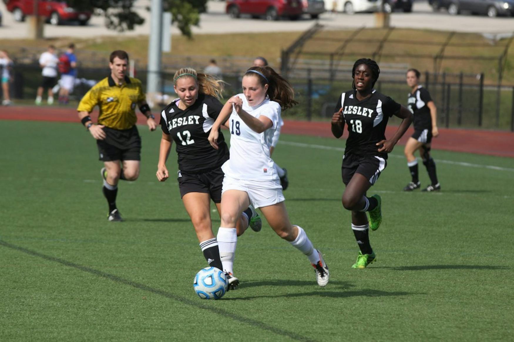 QUICK PASS: Forward Samantha Schwartz ’18 (right) sprints ahead of a Lesley College defender in the team’s 1-0 win on Sept. 23.