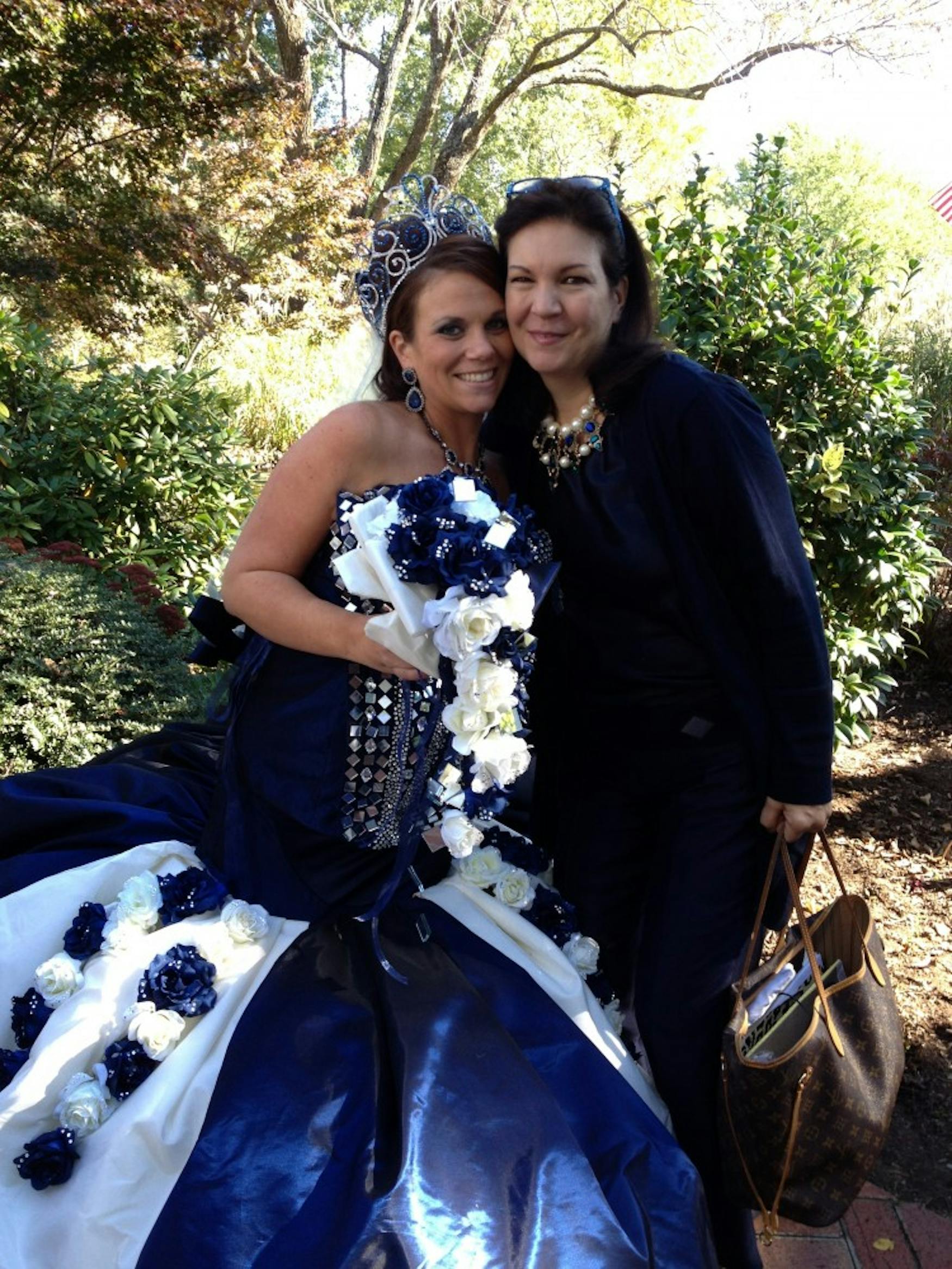BRIDE IN BLUE: Celli (right) poses with a bride dressed in one of her colorful wedding gowns.