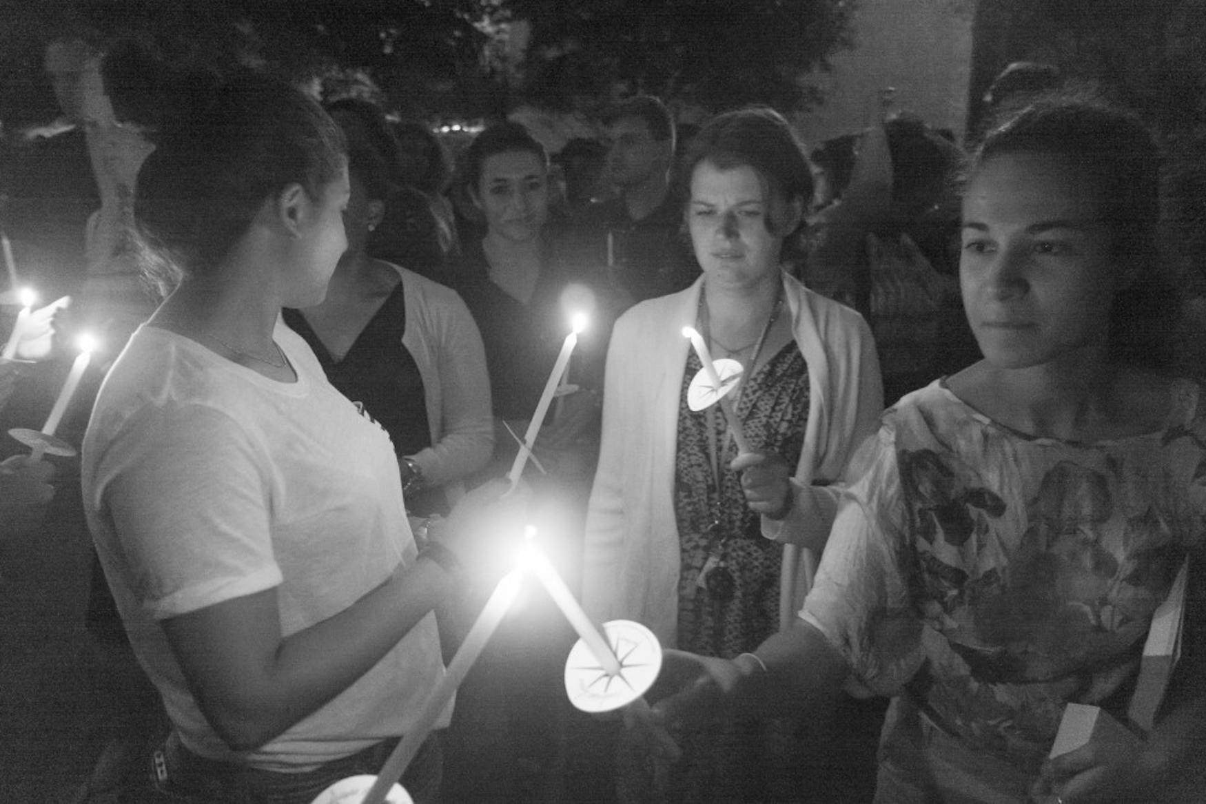 Students lit candles at the vigil held to remember Michael Brown of Missouri at Chapels Pond on Thursday night.