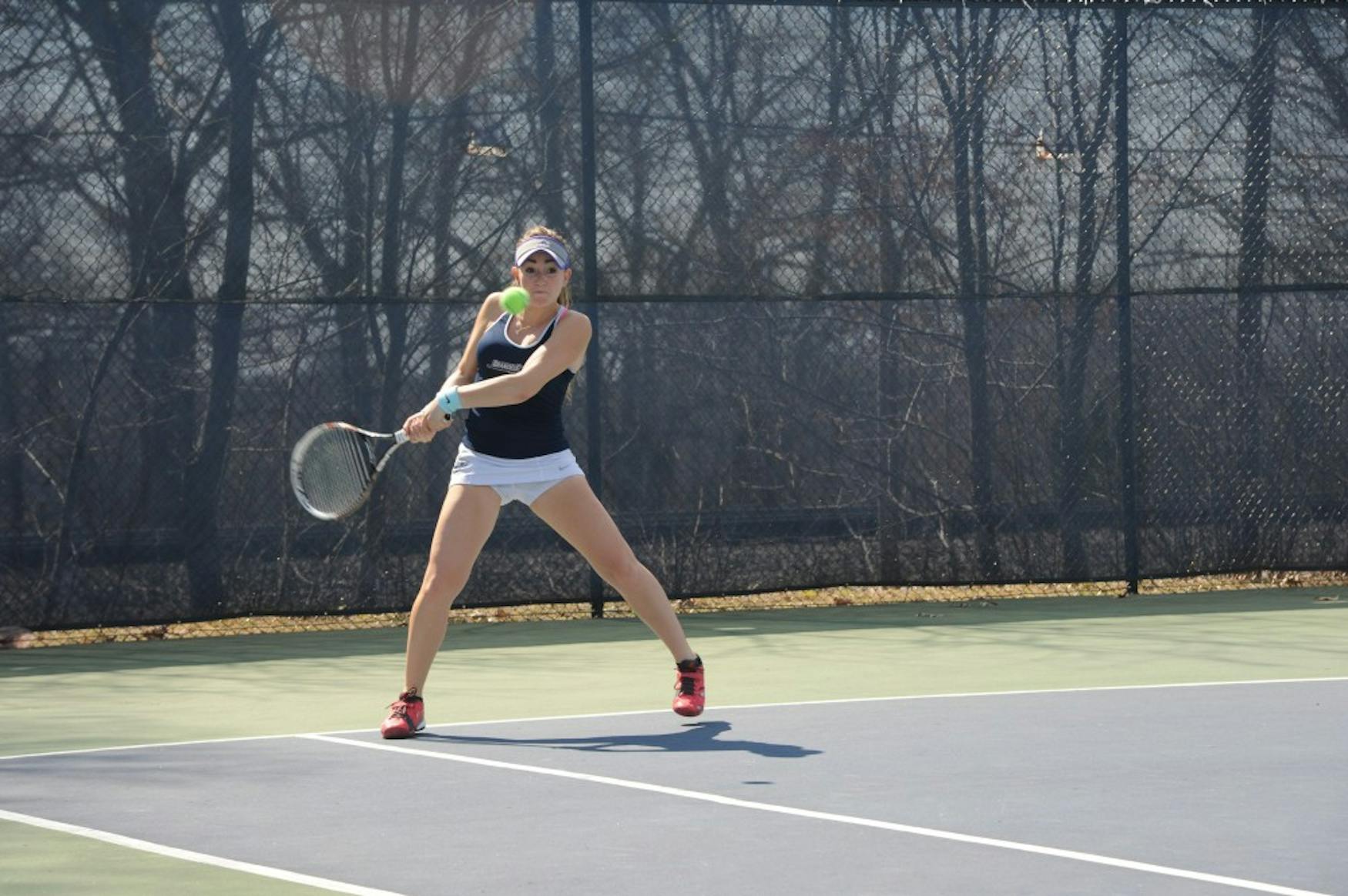 REACHING BACK: Haley Cohen ’18 takes a backhand stroke in a match against New York University at home on April 18.