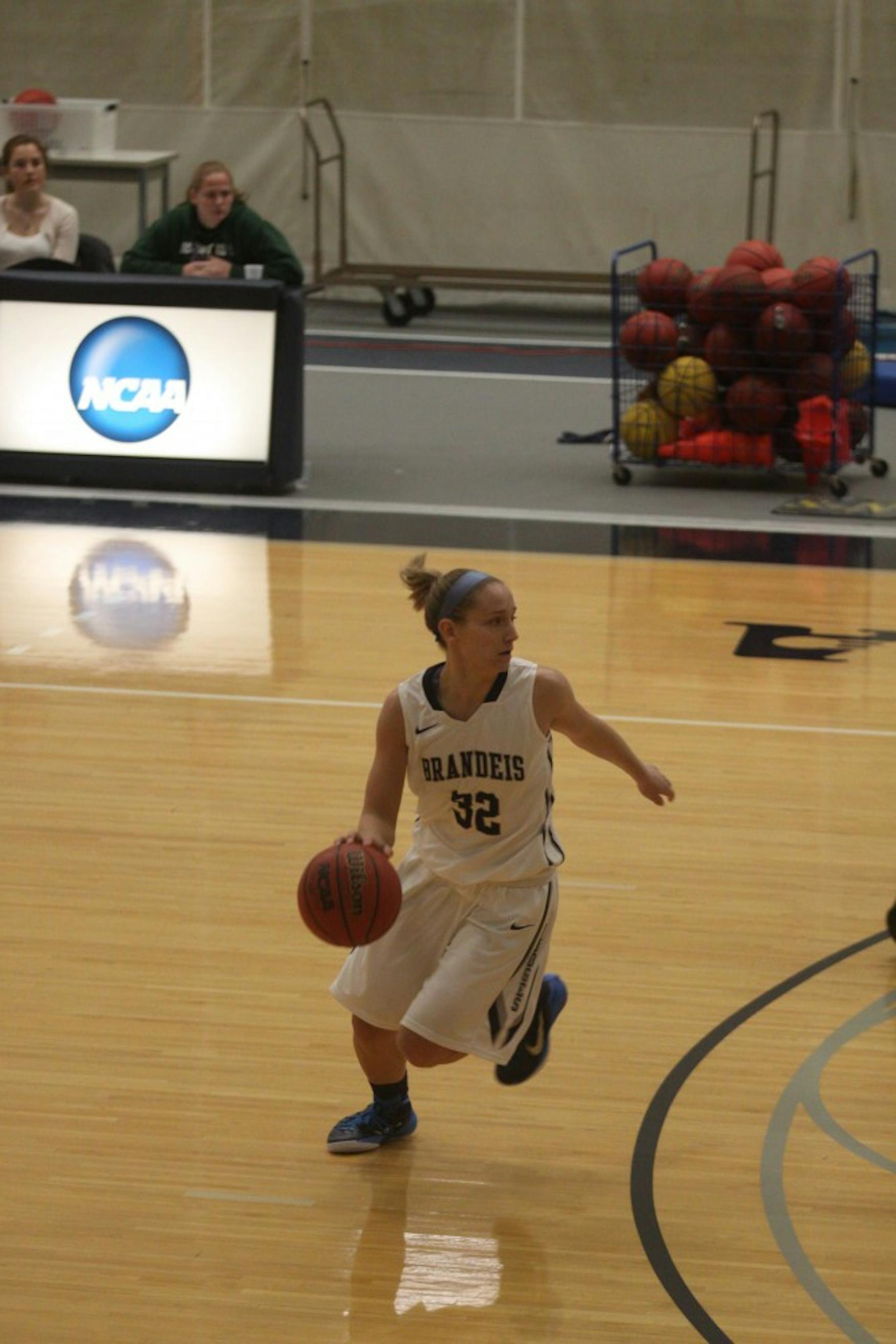 QUICK DRIBBLE: Guard Hannah Cain ’15 dribbles at the top of the key during the team’s 77-39 victory over Salve Regina University.