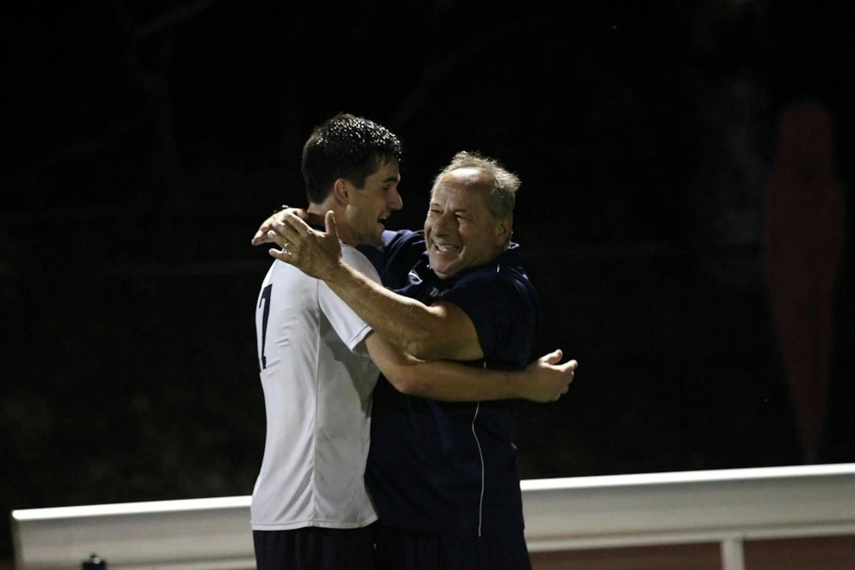 VICTORY EMBRACE: Coach Coven hugs midfielder Josh Ocel ’17 at the game last Saturday when the Judges defeated longtime rivals, Babson College.