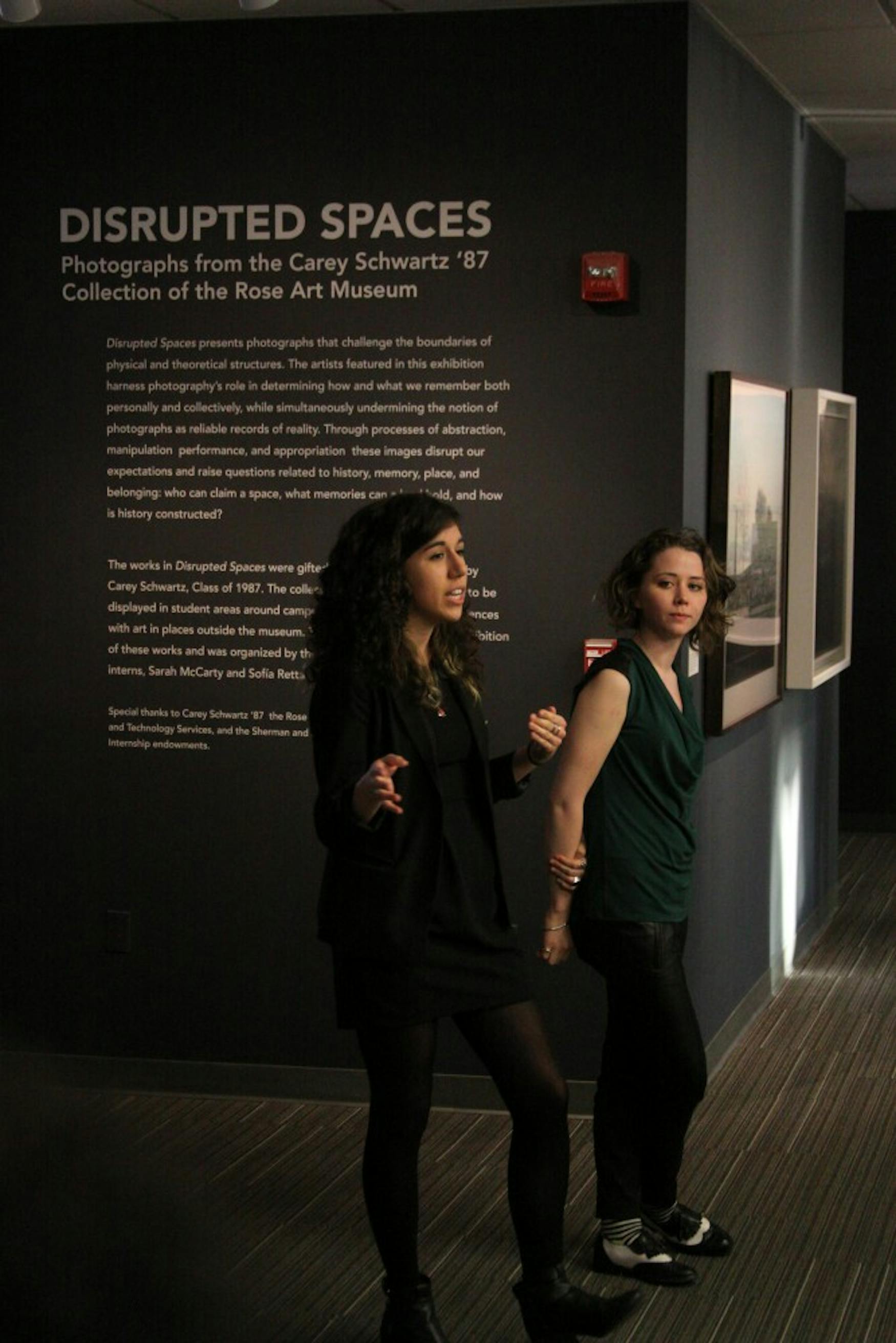 A NEW SETTING: Curatorial Interns Sofia Retta ’15 (left) and Sarah McCarty ’15 discuss how the exhibit will affect Farber’s study space and explain their choice in location.