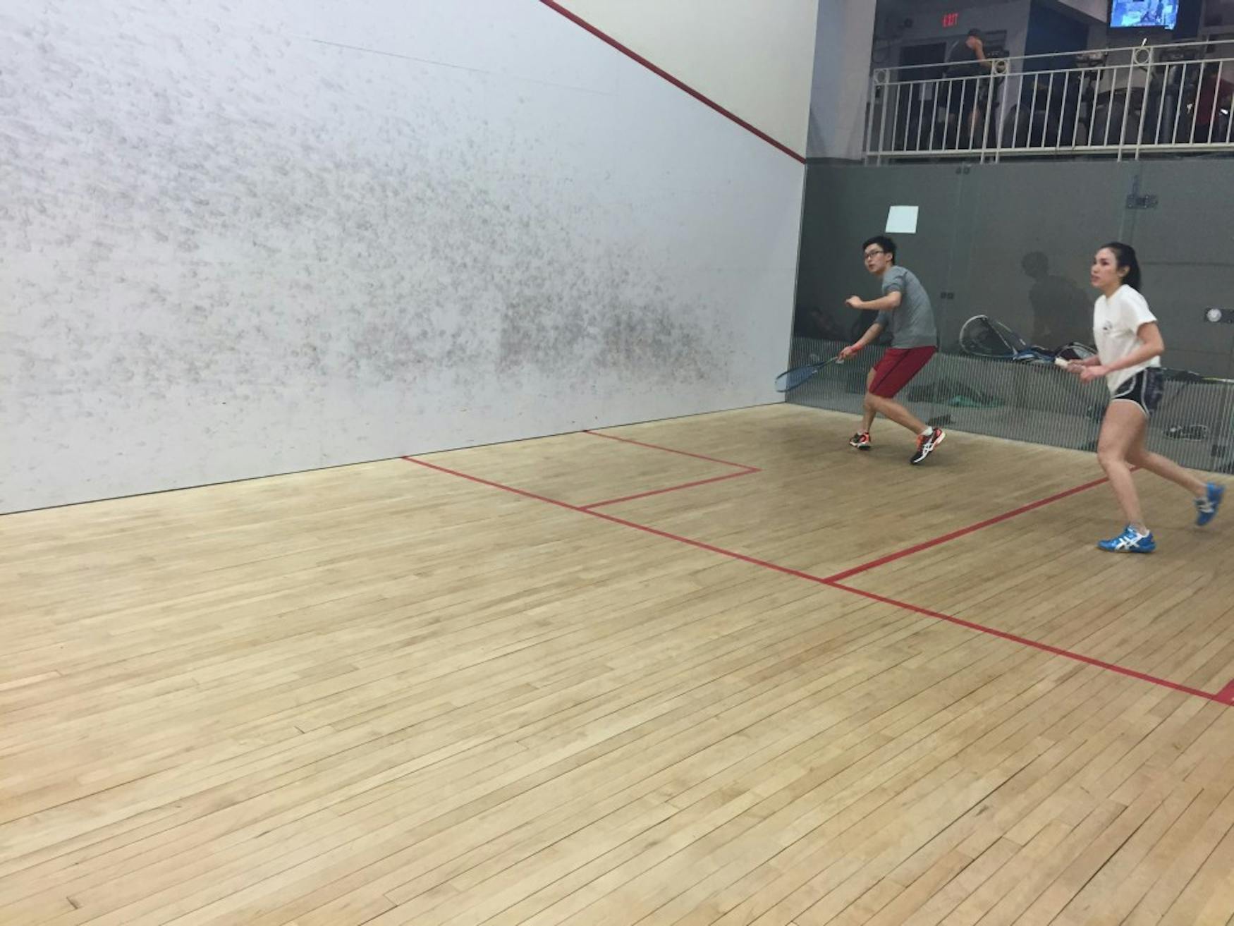 HITTING THE COURTS: Squash players Michael Jiang ’18 (left) and Rie Ota ’18 (right) play during a team practice last month.