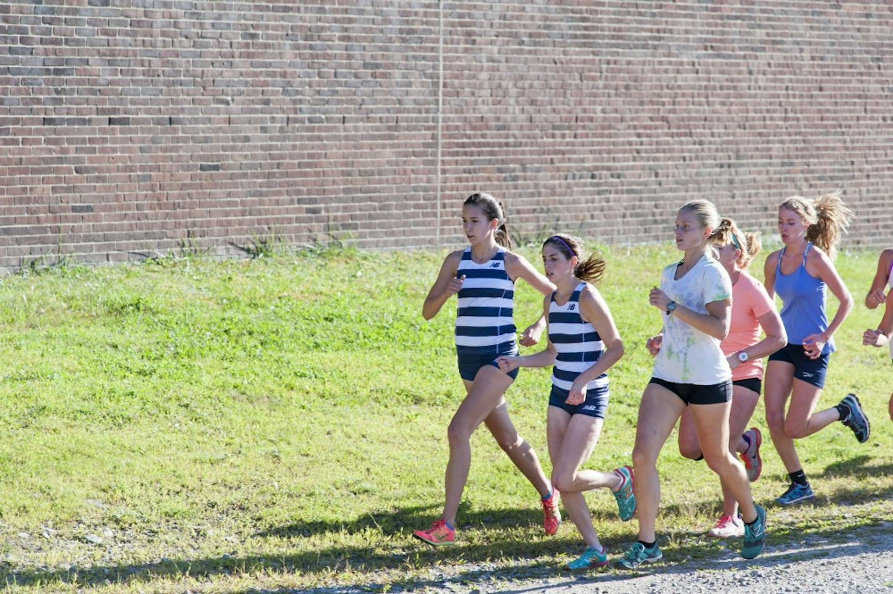 KEEPING PACE: Kelsey Whitaker ’17 (left) runs during the Judges’ home meet against Southern Maine University on Aug. 29.. a.