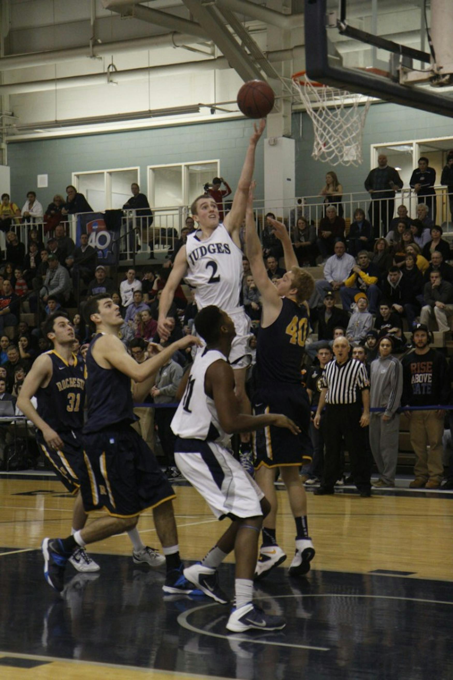FINGER ROLL: Guard Colby Smith ‘16 attempts a layup over a University of Rochester defender in the team’s win on Jan 24.