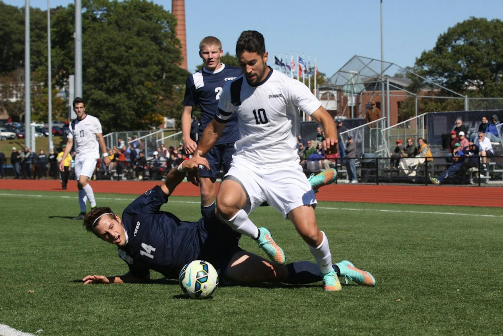 FANCY FOOTWORK: Midfielder Michael Soboff '15 (right) dribbles through a Case Western Reserve University defender on Sunday.