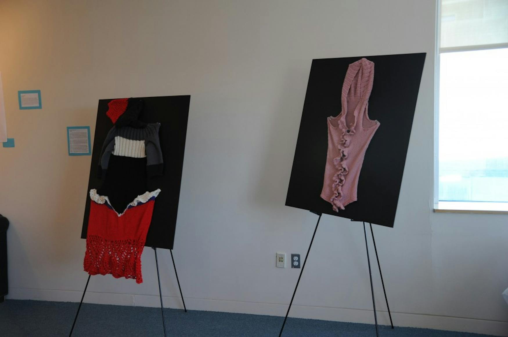 ARTISTIC ATTIRE: Aviva Paiste ’15 created these garmets—a pink sweater and a multicolored dress— with feminist themes in mind. The sweater represents a vagina and the dress also focuses on female anatomy with its widened hips that are accentuated with frills.