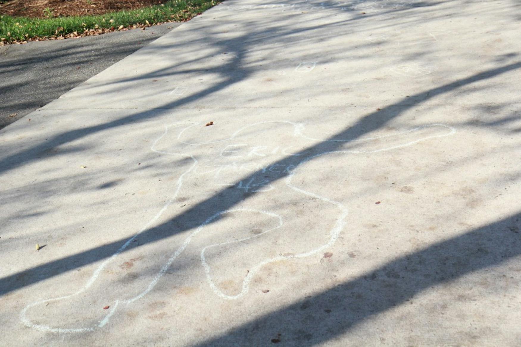 A student group drew chalk figures memorializing black people who lost their lives due to institutional racism.