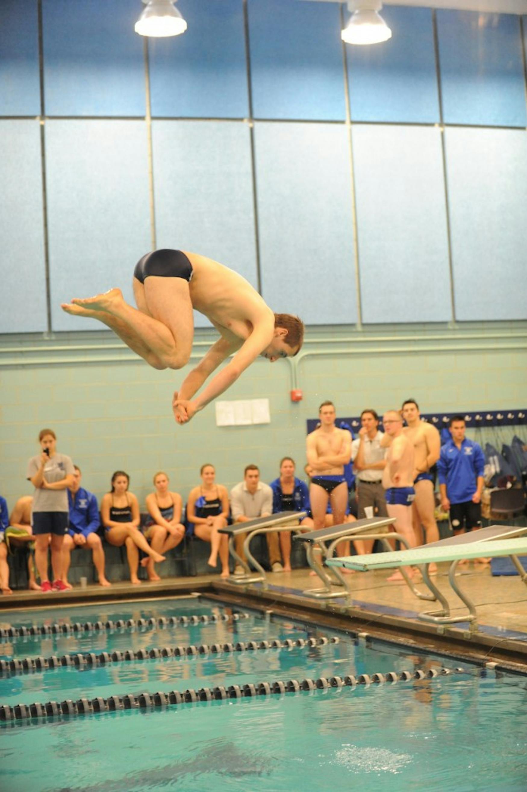 HEAD OVER HEELS: Sam Zucker ’18 curls into a dive during the Judges’ home meet versus Wheaton College on Saturday.