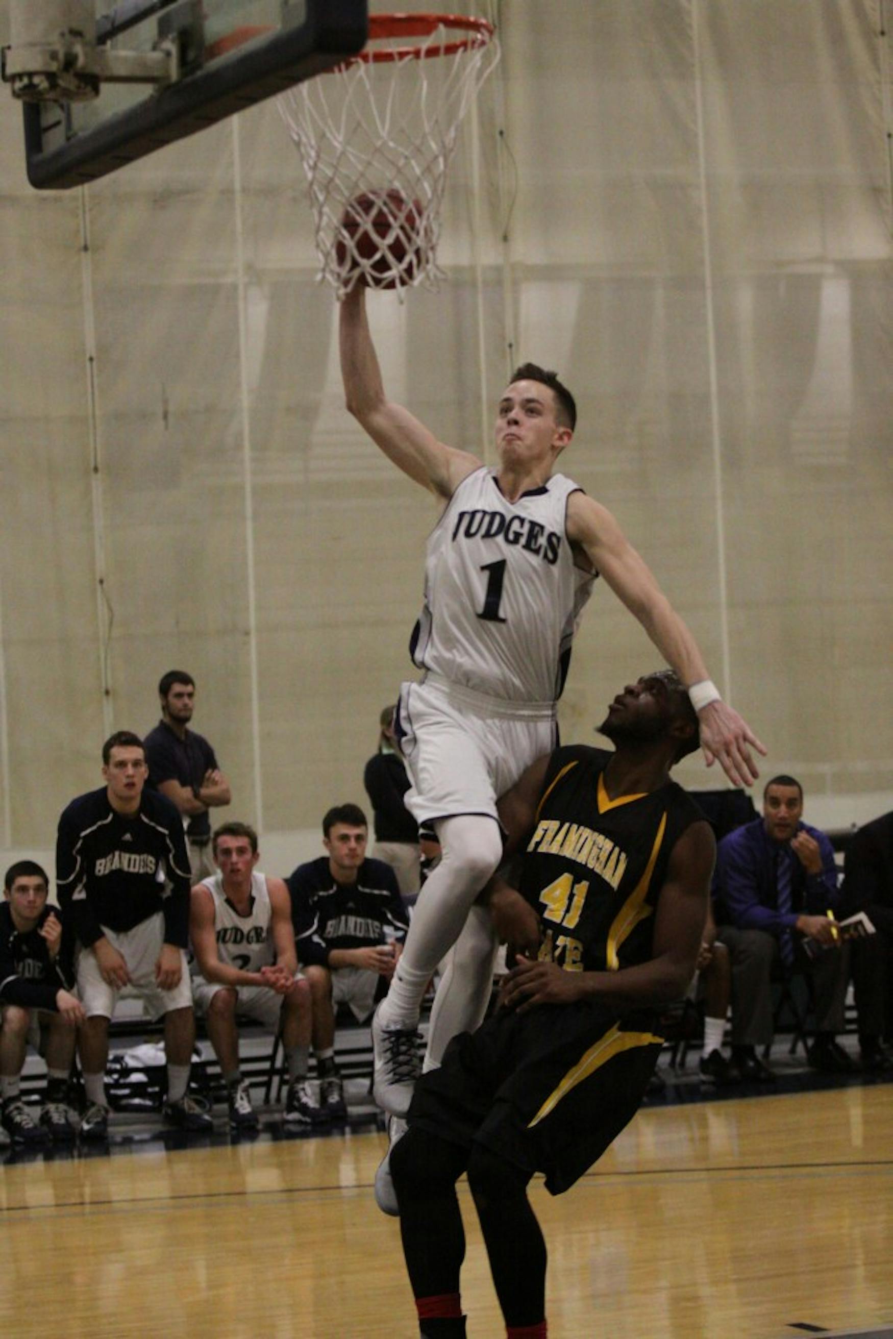BRINGING IT HOME: Guard Tim Reale ’17 goes up for a slam dunk in the team’s 63-51 win over Framingham State University.
