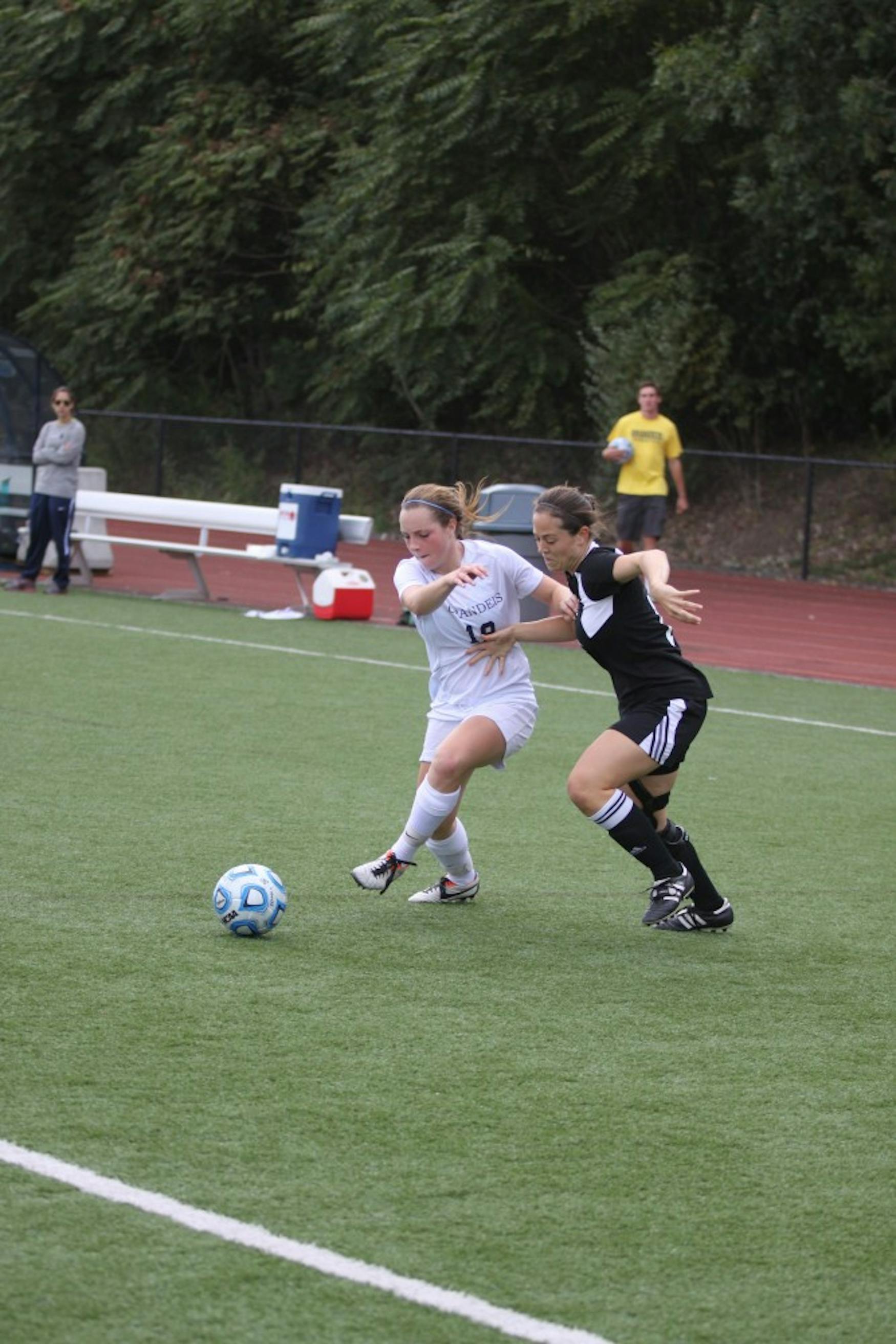 POSESSION BATTLE: Forward Samantha Schwartz ’18 (left) wins possesion from a Lesley College defender in a 1-0 win last Sept.