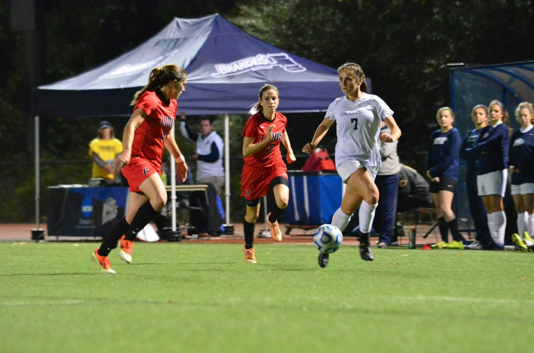 THROUGH BALL: Forward Holly Szafran ’16 (right) dribbles down the wing with two Eastern Nazerene College defenders in pursuit during the Judges’  1-0 win last Tuesday.