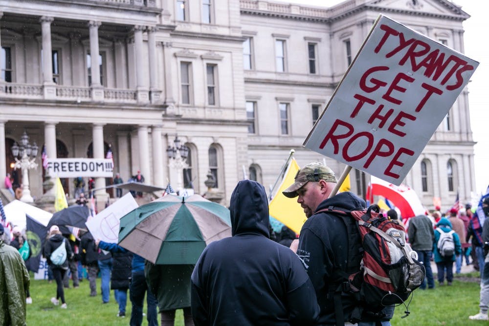 People gather on the lawn of the Capitol at the rally April 30, 2020 in Lansing.