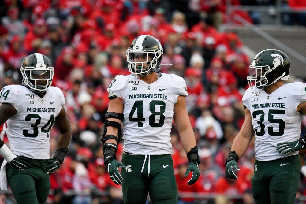 <p>Freshman running back Anthony Williams Jr. (34), senior defensive end Kenny Willekes (48) and senior linebacker Joe Bachie (35) during the game against Wisconsin at Camp Randall Stadium on Oct. 12, 2019. The Spartans lost to the Badgers 38-0. </p>