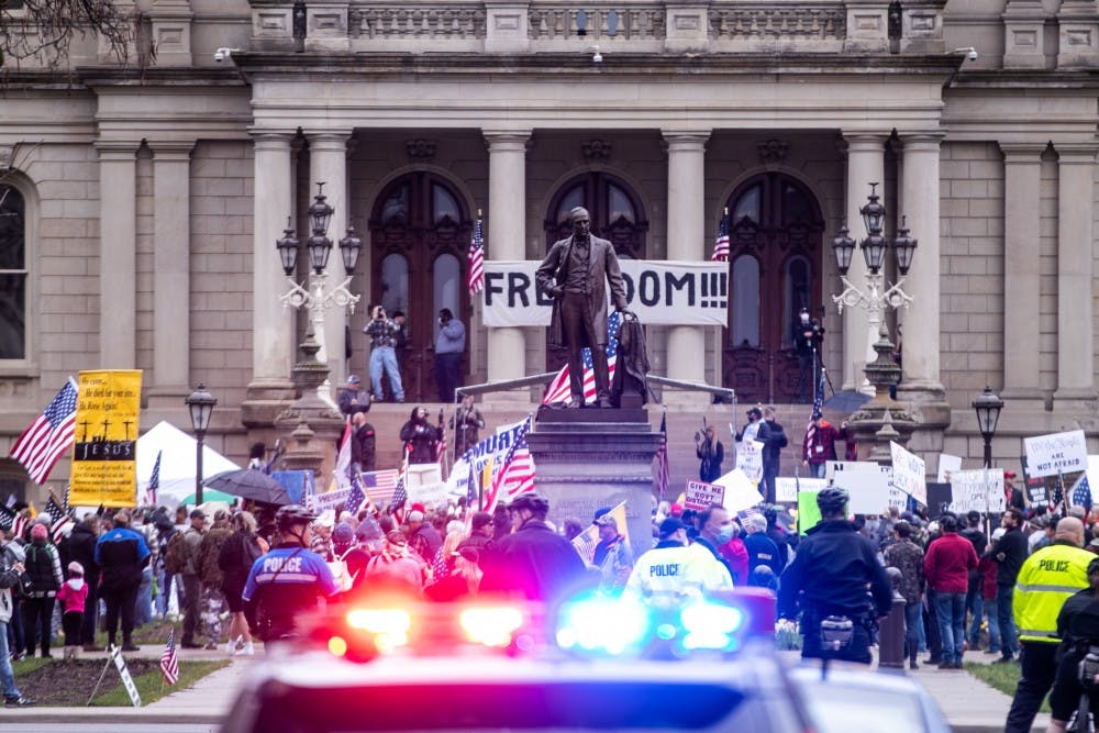 <p>People gather on the lawn at the rally at the Capitol April 30, 2020 in Lansing. Crowds gathered to protest Governor Whitmer&#x27;s stay-at-home order. The protest started outside before crowds moved inside where they were stopped from entering the House and Senate due to social distancing guidelines. While the protest was namely about the stay-at-home order, individual protestors&#x27; priorities varied from abortion to President Trump&#x27;s reelection.</p>