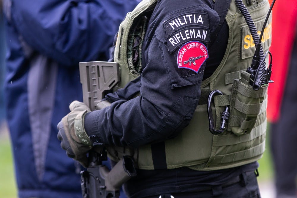 A man in tactical gear stands at the rally at the Capitol April 30, 2020 in Lansing.