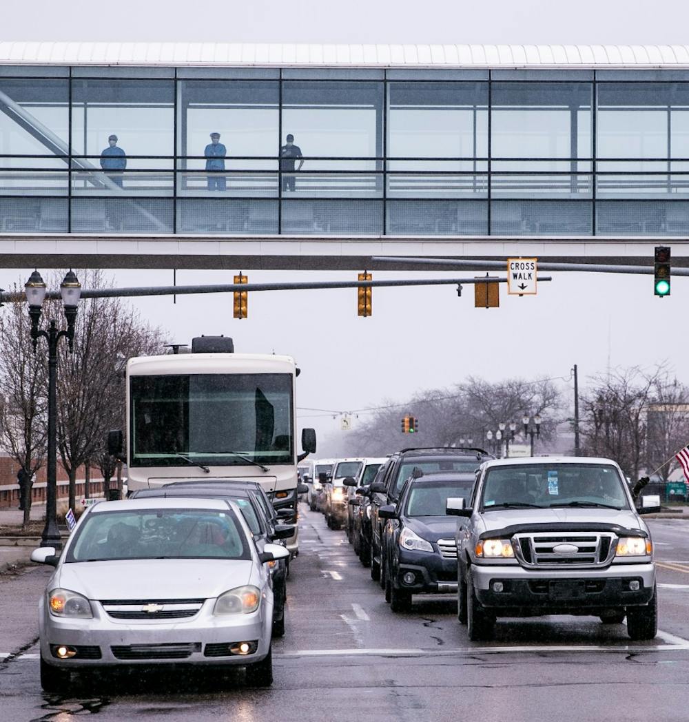 Sparrow Hospital workers overlook the traffic from the Operation Gridlock protest April 15, 2020 in Lansing.