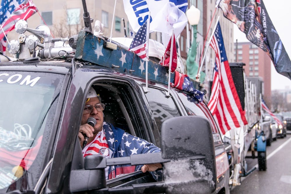 Rob Cortis speaks into his microphone at the Operation Gridlock protest April 15, 2020 in Lansing.