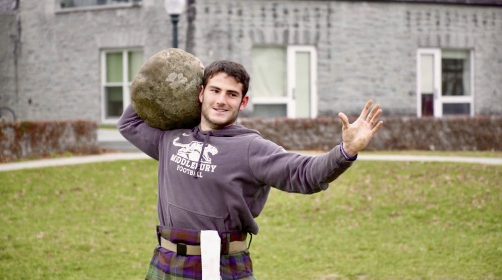 Middland Games competitor Jack Greenberg ’23.5 executes the stone-to-shoulder event at a practice session outside of Coffrin Hall. Athletes have one minute to perform as many repetitions as possible from the ground to one shoulder with the heaviest of four stones that they can manage.
