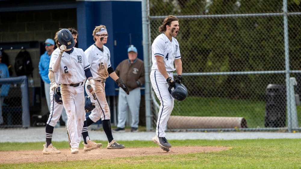 Nathan Samii ’25 (#4) jumps in celebration during Middlebury’s doubleheader against Tufts on May 7 at Forbes Field. (Courtesy of Will Costello)