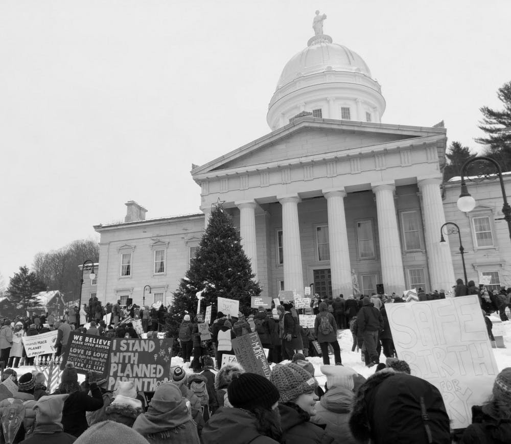 <span class="photocreditinline">NICK GARBER/ THE MIDDLEBURY CAMPUS</span><br />Protestors, bundled up for the frigid weather, throng the steps at the Statehouse in Montpelier.