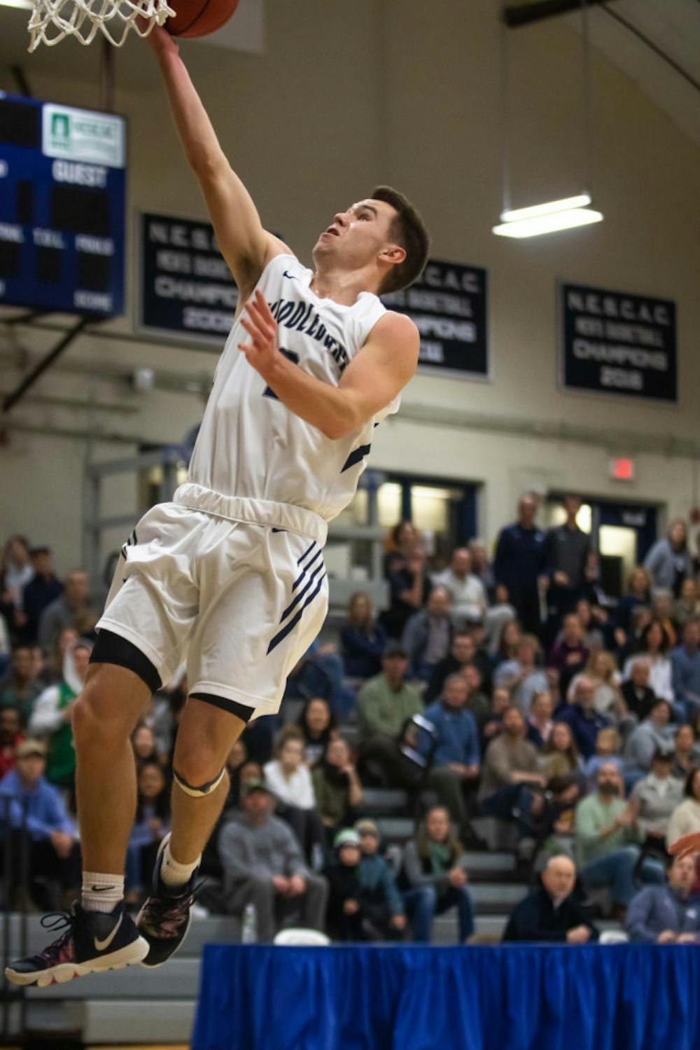 <span class="photocreditinline"><a href="https://middleburycampus.com/39670/uncategorized/michael-borenstein/">MICHAEL BORENSTEIN</a></span><br />Griffin Kornaker ’21 finishes a layup in a game against Tufts.