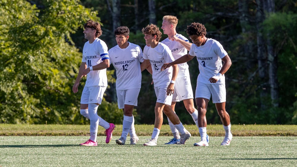 The Middlebury men’s soccer team celebrates a goal together.