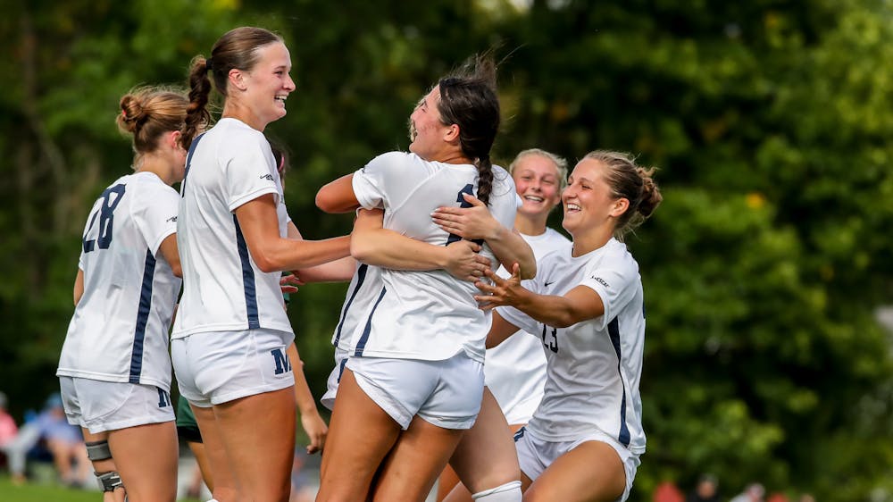 Middlebury Women's Soccer celebrates a goal against Castleton.