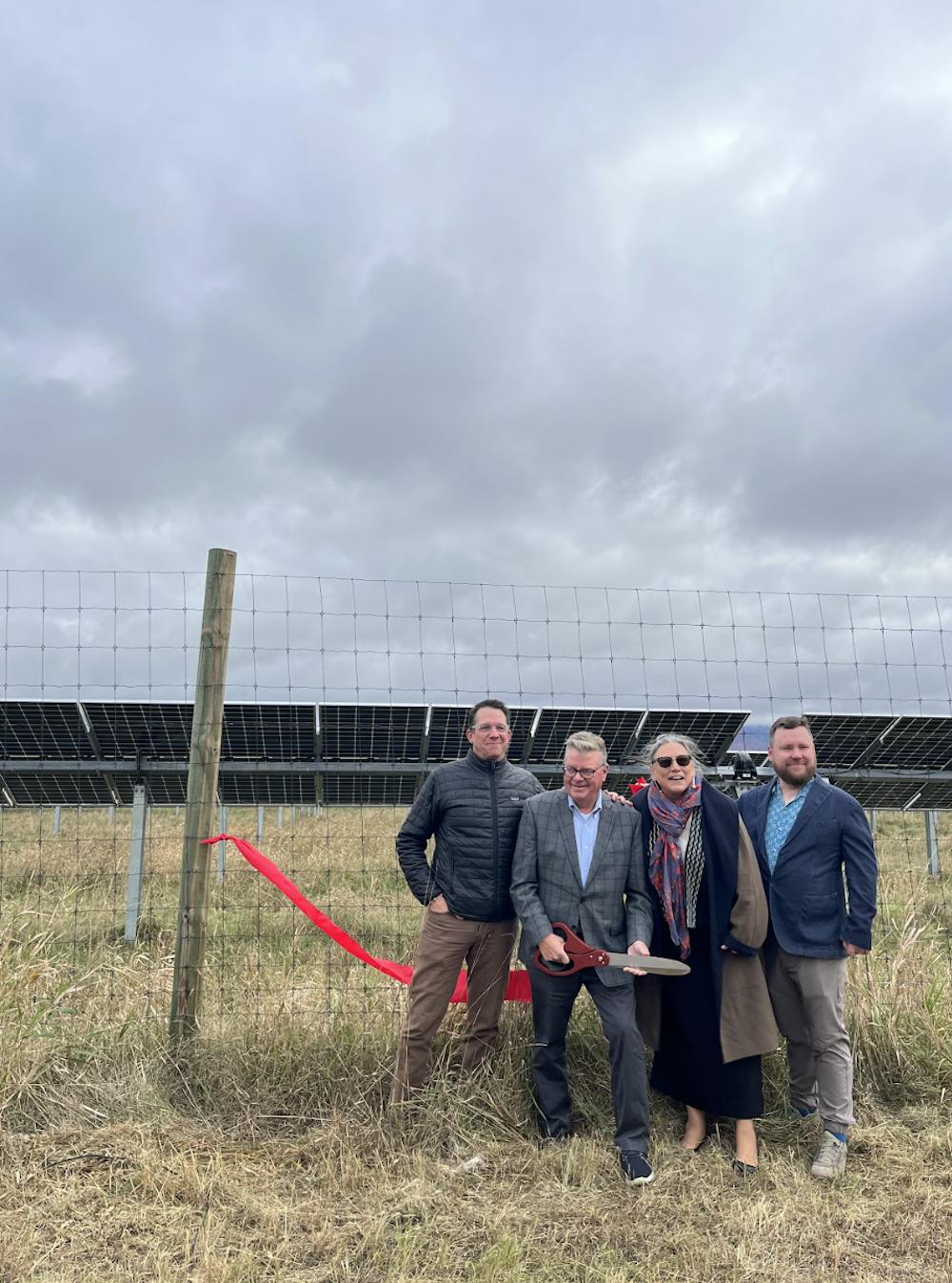 President Patton stands with Encore Renewables employees after cutting the ribbon to open the college's new solar array on South Street Extension.