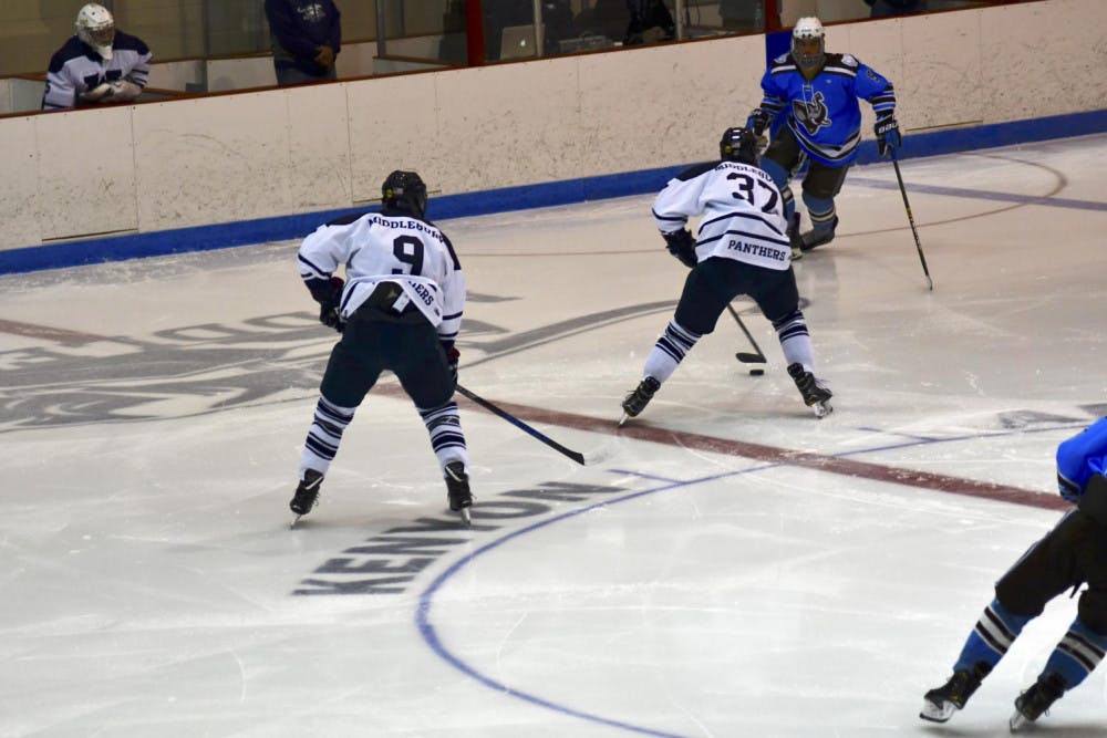 <span class="photocreditinline">MAX PADILLA/THE MIDDLEBURY CAMPUS</span><br />Owen Powers ’20 and Zach Shapiro ’22 fight for the puck against Tufts on Dec. 1.