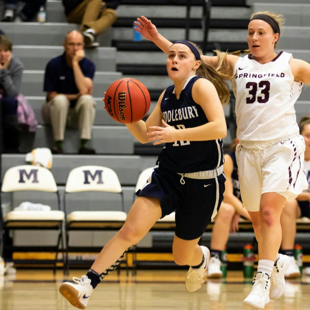 <span class="photocreditinline">MICHAEL BORENSTEIN/THE MIDDLEBURY CAMPUS</span><br />Emily Wander ’21 breezes past a Springfield defender, preparing for a layup, at the Middlebury Tip-Off Classic.