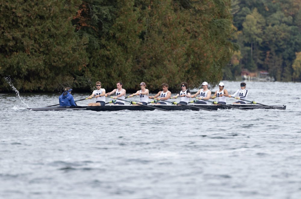The Middlebury men’s varsity boat cuts through choppy waters on Lake Dunmore.