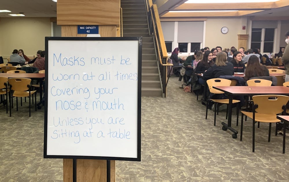 <p>A sign in Proctor Dining Hall on March 4 reminded students to wear masks unless seated at a table.</p>