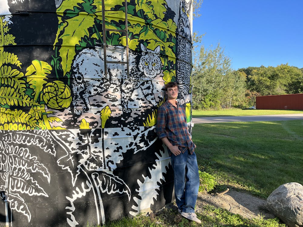 Wyatt Robinson '24.5's summer was spent designing and painting the mural on the silo outside the Recycling Center.