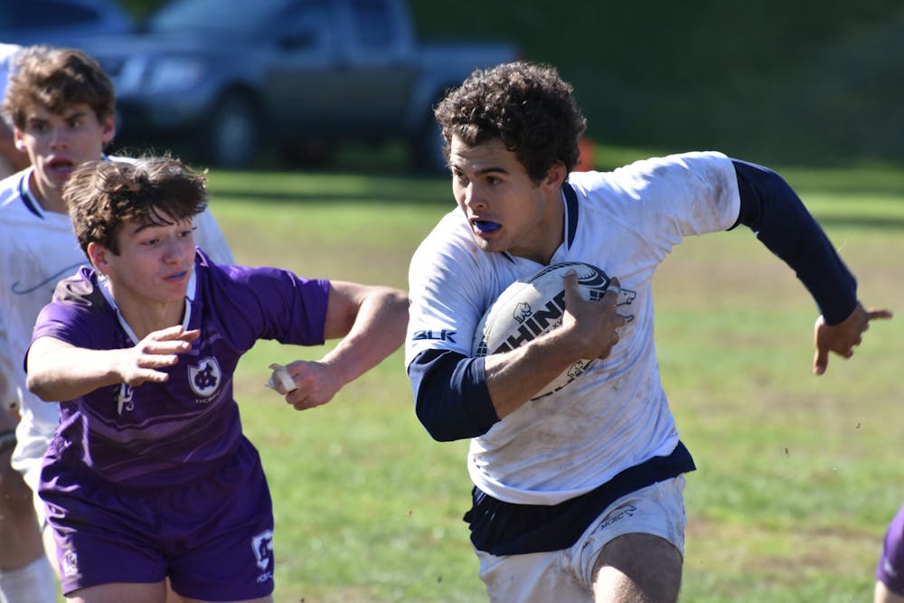 Men’s rugby captain Red Douoguih ’22.5 escapes a tackle during the Panthers’ 20–17 win against Holy Cross on Oct. 23. (Courtesy of Bo Ebby)