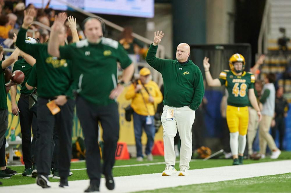 Phelps standing on the sidelines of a football game at his old college, North Dakota State.