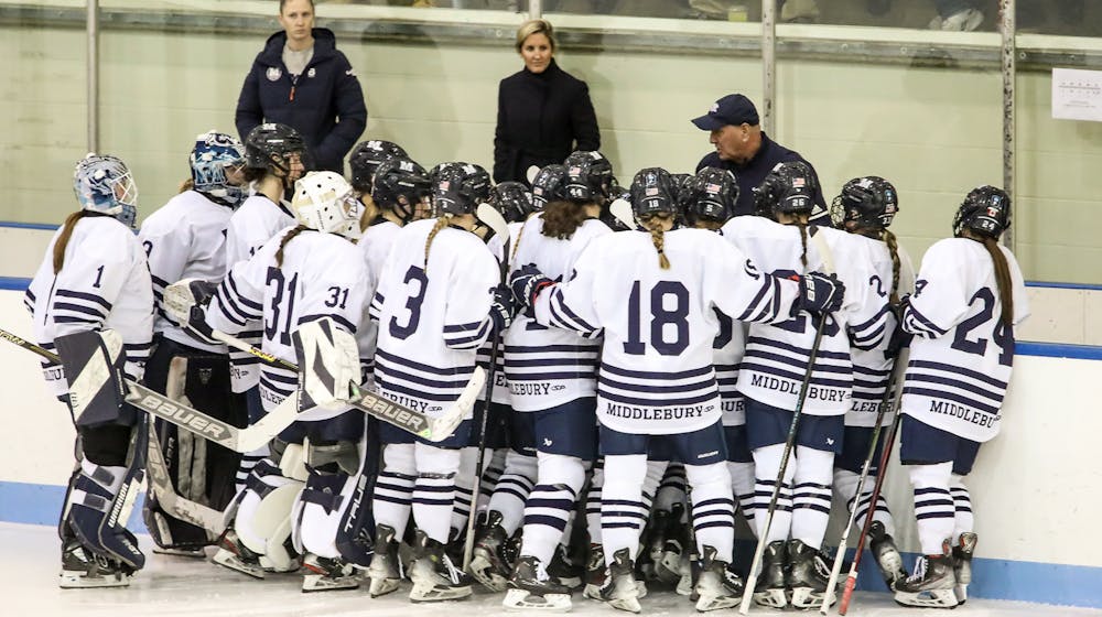 The women's hockey team in a huddle before facing Colby.