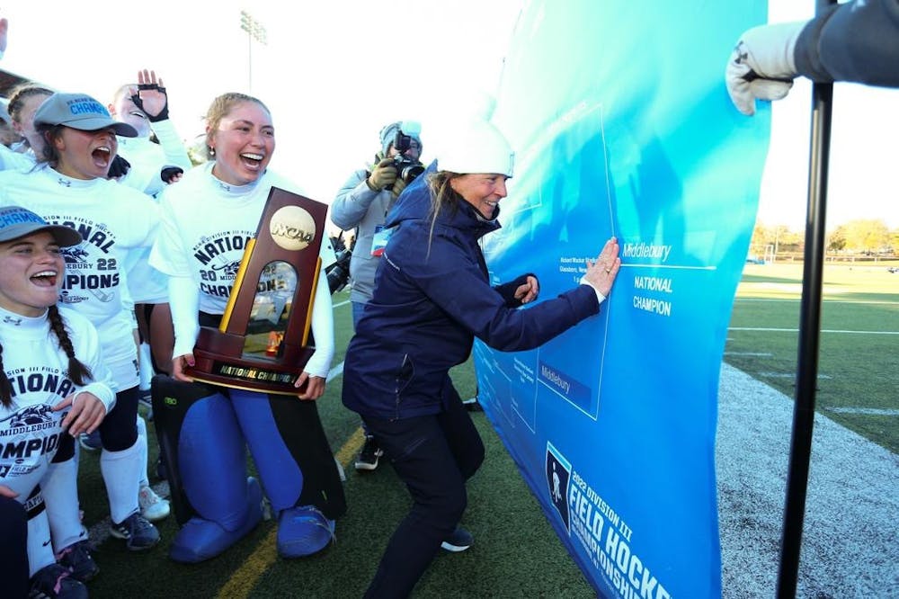 Coach Katherine DeLorenzo puts Middlebury’s name at the end of the bracket. 