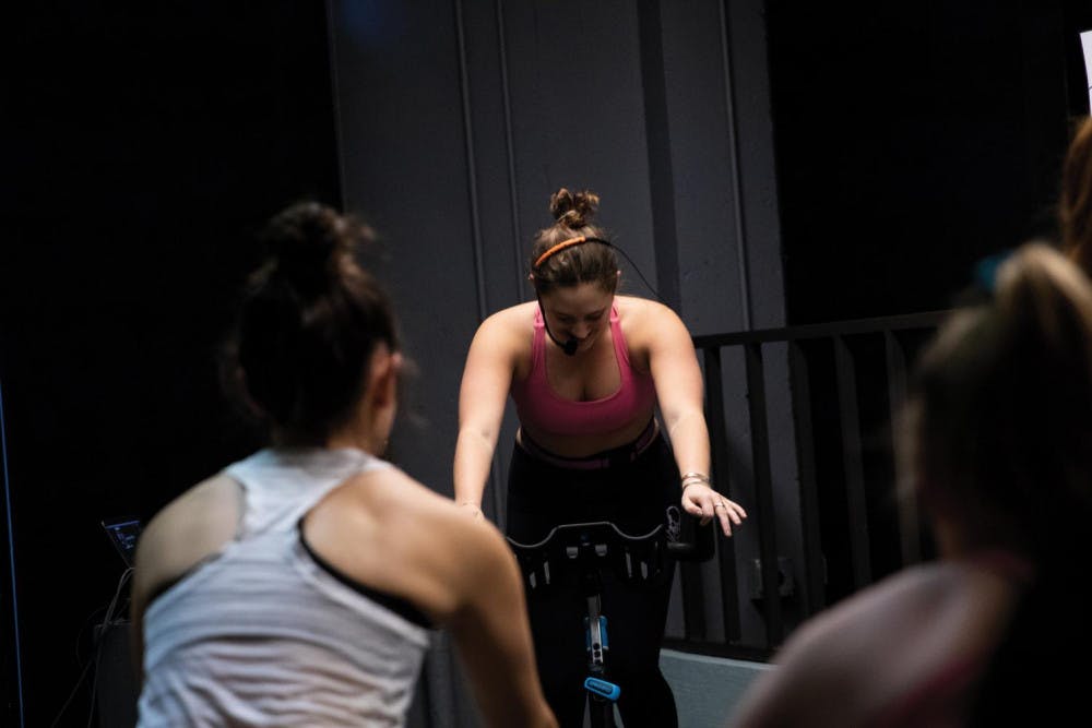 <span class="photocreditinline">SOPH CHARRON</span><br />Abby Okin ’20 leads a spin class last Tuesday, one of two weekly sessions she teaches as a YouPower instructor. This is Okin’s third semester teaching YouPower classes.