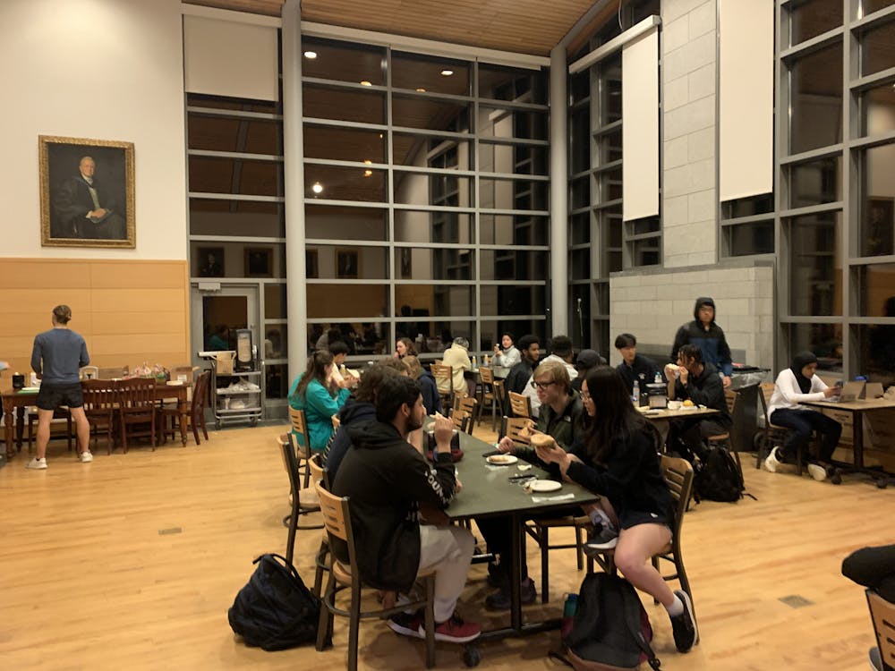 Students socialize and eat in Fireplace Lounge during 10 o'clock Ross. Students choose cereal, granola bars, juice and other snacks.