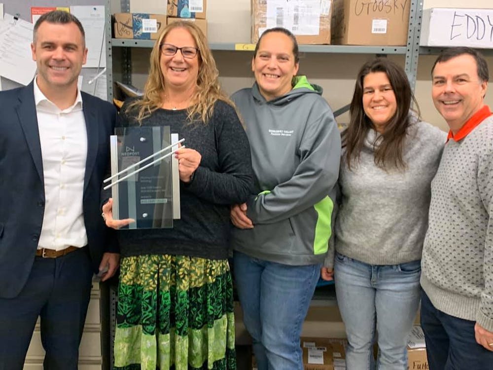 <span class="photocreditinline">COURTESY PHOTO</span><br />The Mail Center received an award for efficiency after delivering 89,000 packages last year. Staff members pose with the award (above).