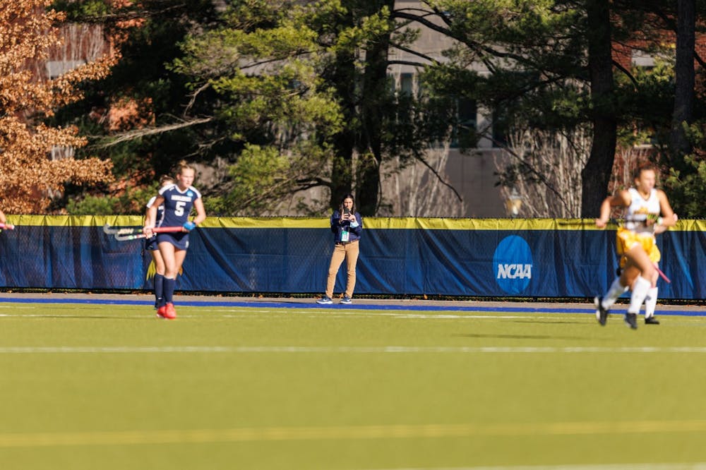 Ali Paquette (center) captures a photo during a Middlebury field hockey game. Courtesy of Frank Poulin 
