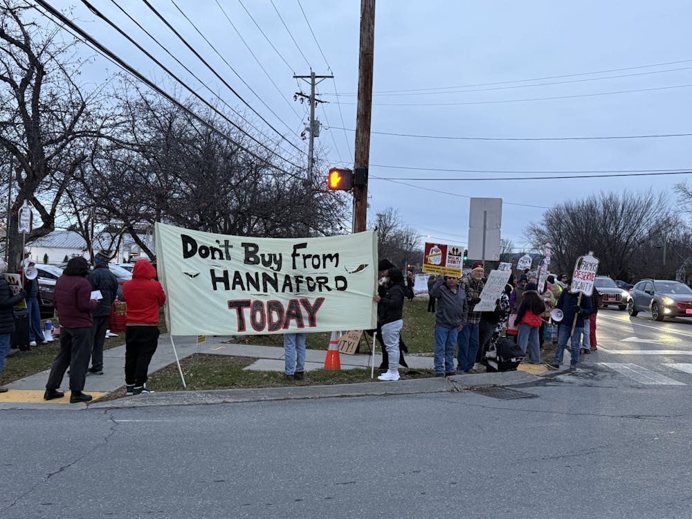 A picket line organized by Milk With Dignity forms outside of Middlebury's Hannaford location.